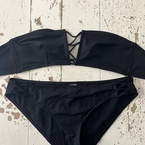 ERES Swim black bandeau bikini with open détail in front and sides. Super chic.
